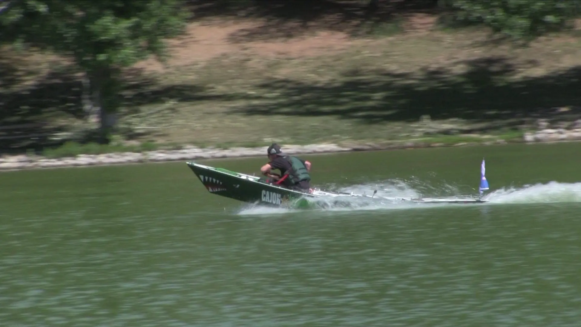 A racer flies through the water in a student-built speed boat.