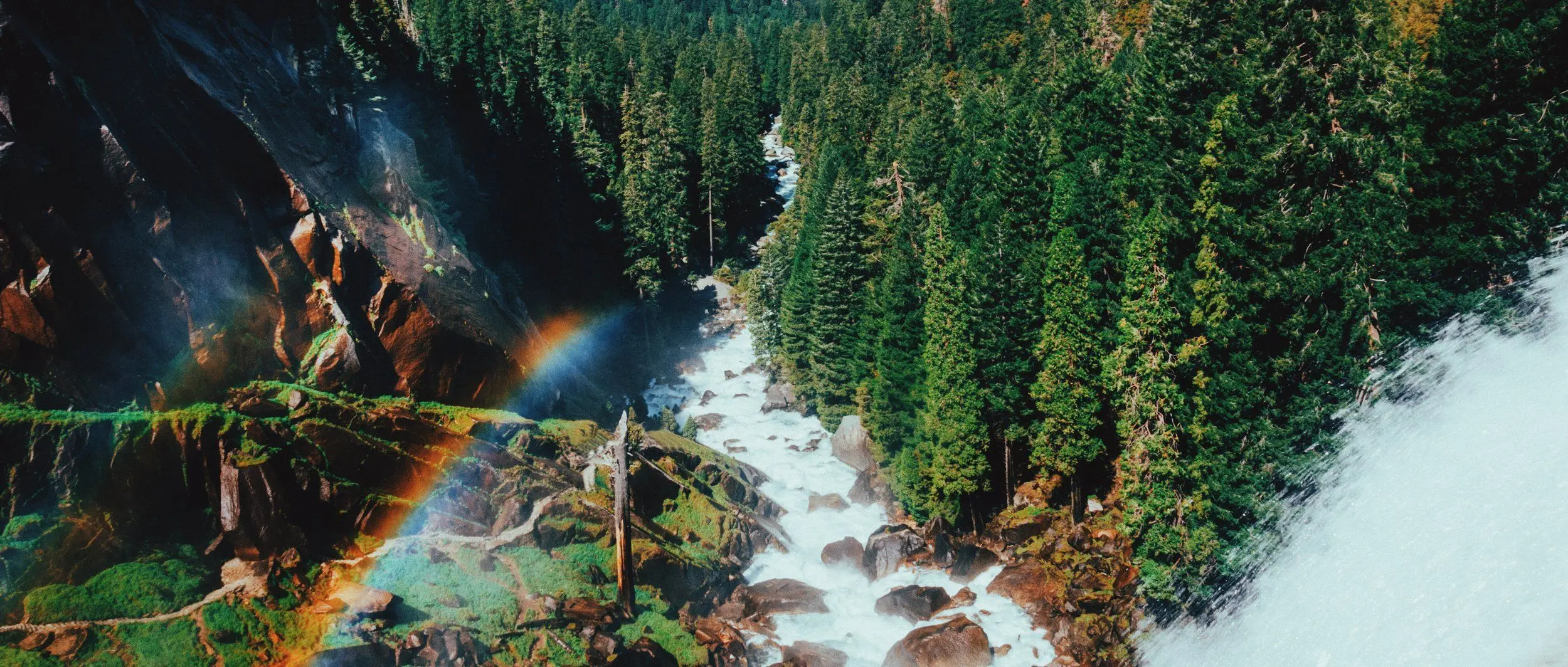 Aerial shot of the Merced River and a misty double rainbow as seen from Vernal Fall.
